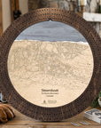 Rustic Mocha Steamboat ski map cribbage board staged with playing cards and après-ski snacks in a mountain lodge.