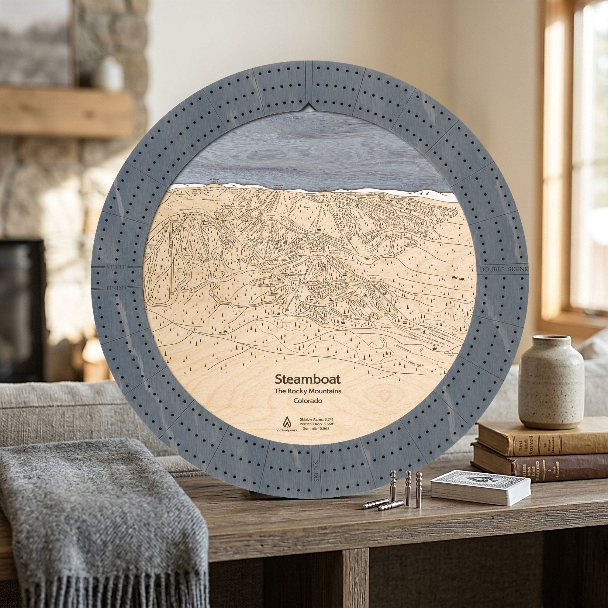 Graphite Grey Steamboat wooden cribbage board displayed in a bright ski home as a unique gift for skiers.
