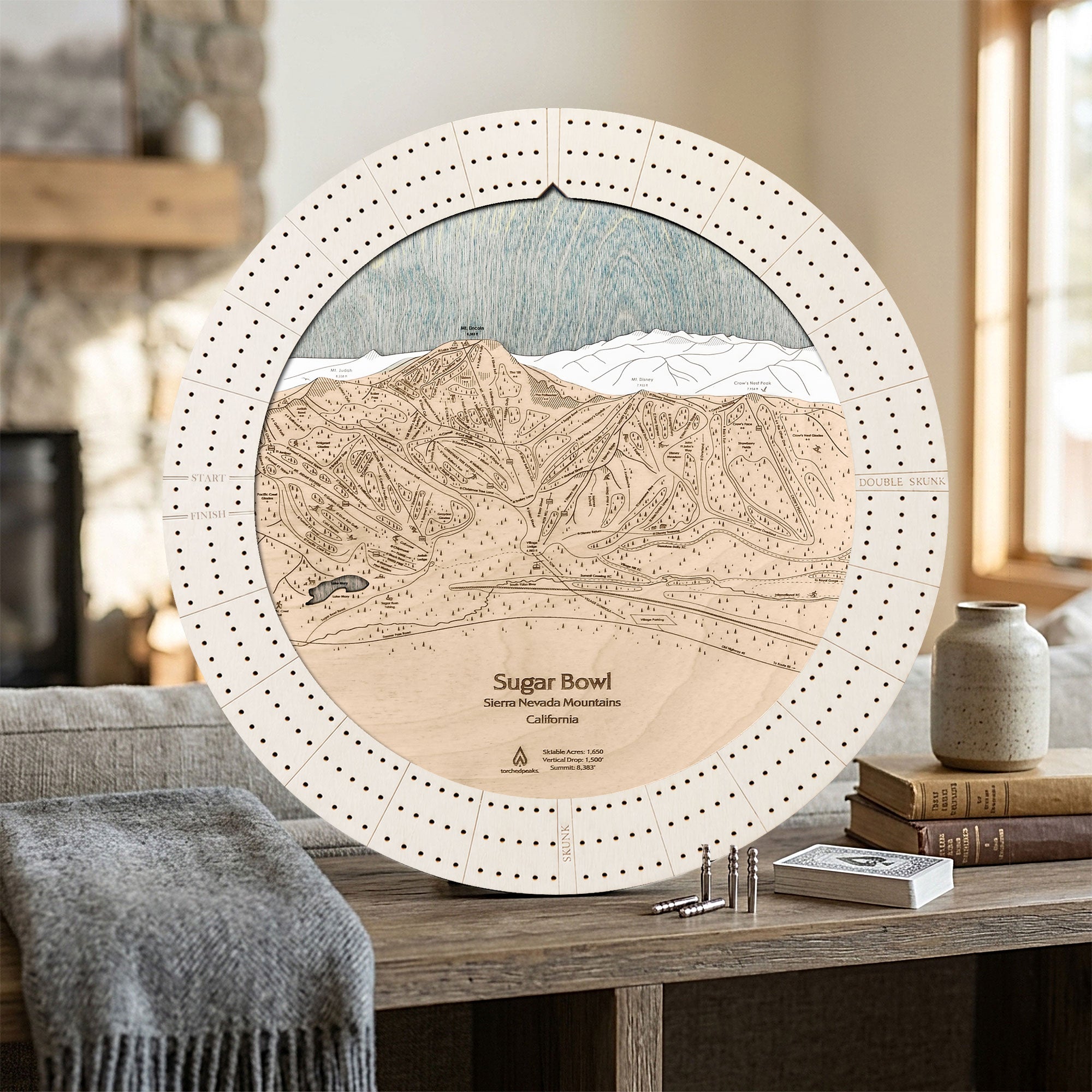 Handcrafted Sugar Bowl ski map cribbage board in Arctic White displayed in a bright mountain home.