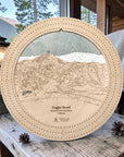 Sugar Bowl wooden ski trail map cribbage board in Birch displayed on a rustic cabin bench.