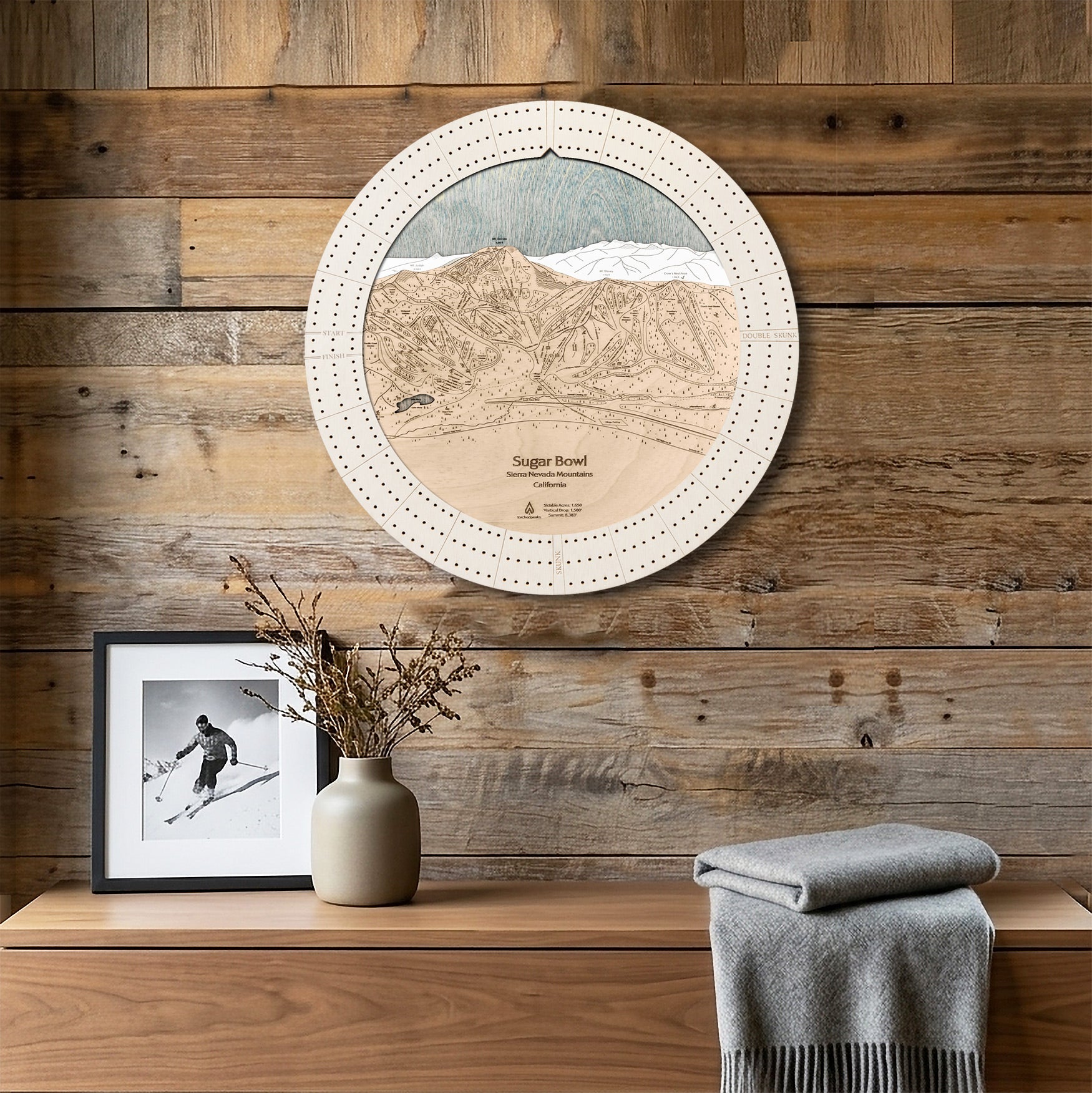 Sugar Bowl ski map cribbage board displayed as round wall art above a rustic wood console