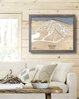 Framed 3d wood map of Terry Peak Ski Resort on a wall in a living room of a cozy skiing cabin. 