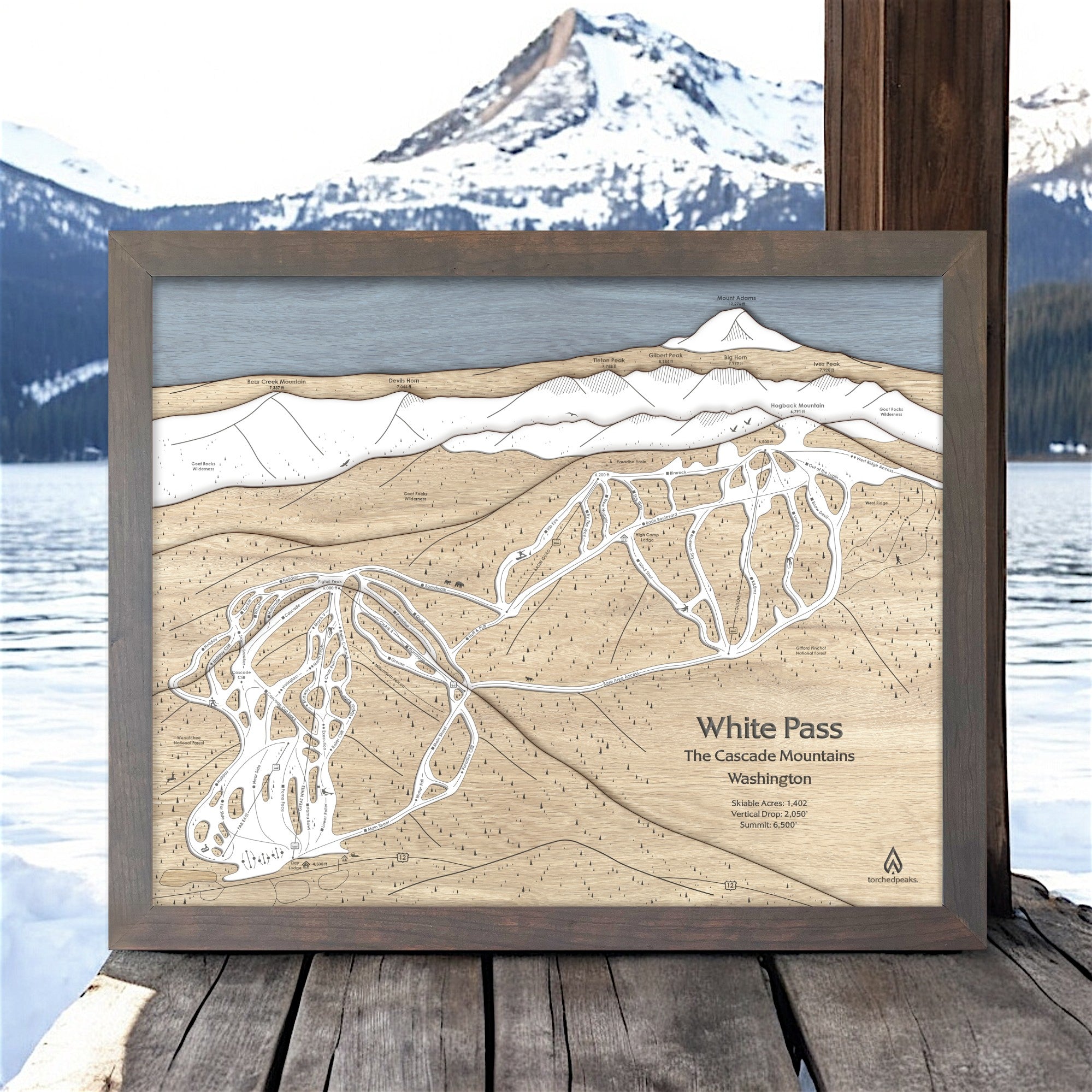 Wooden layered map of White Pass Ski Area with a mountainous landscape in the background