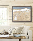 Framed map of White Pass Ski Trails on a wall above a sofa in a cozy living room  of ski chalet.
