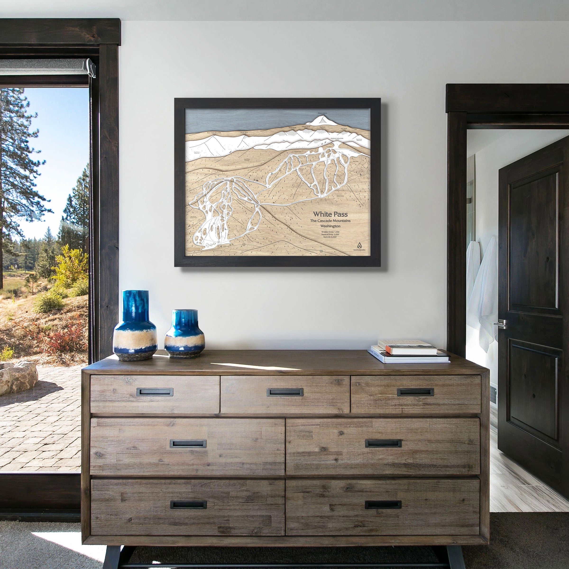 Large format artwork of White Pass Ski Resort featured above a dresser in a modern ski cabin. 