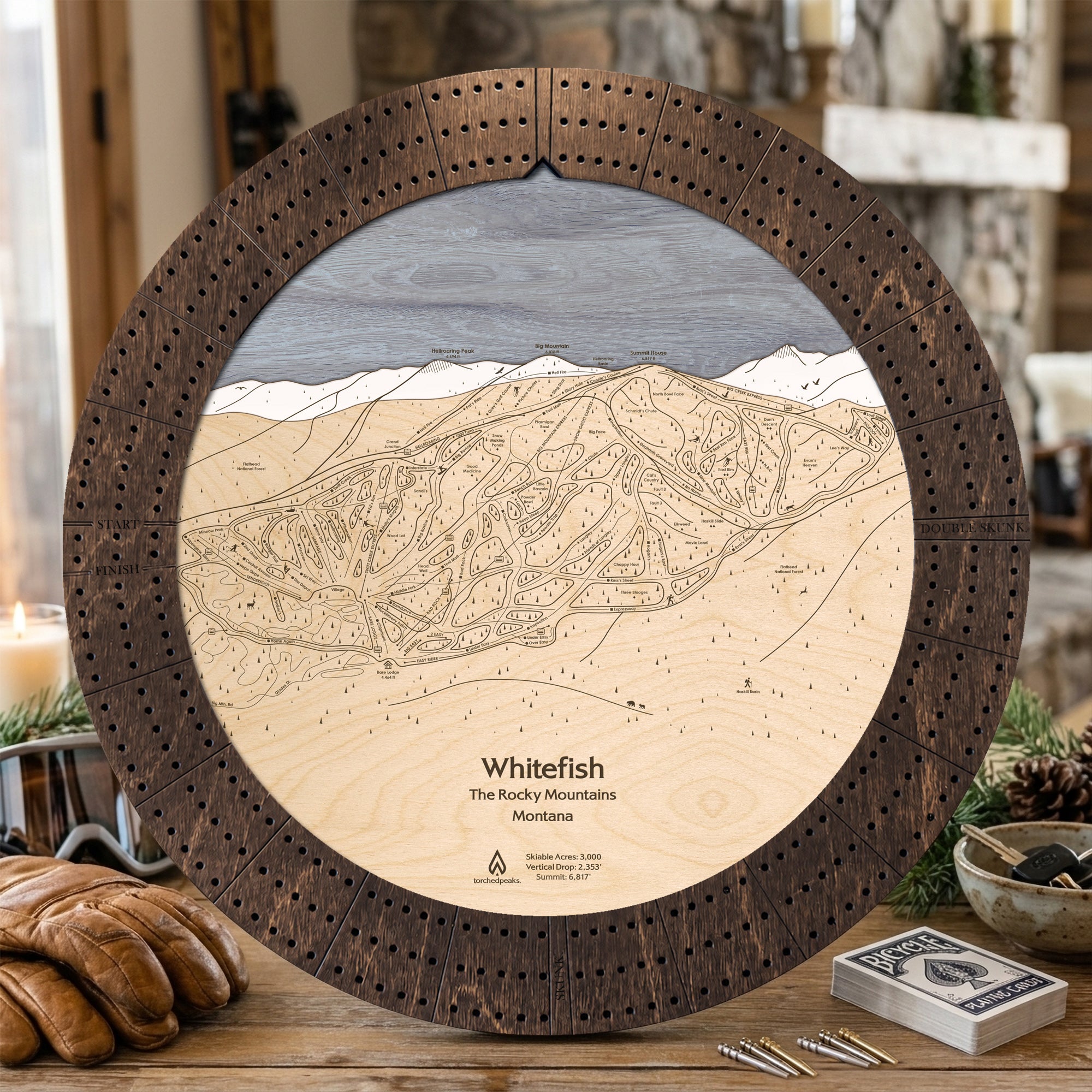 Rustic Mocha Whitefish Mountain cribbage board displayed with playing cards and après-ski snacks.