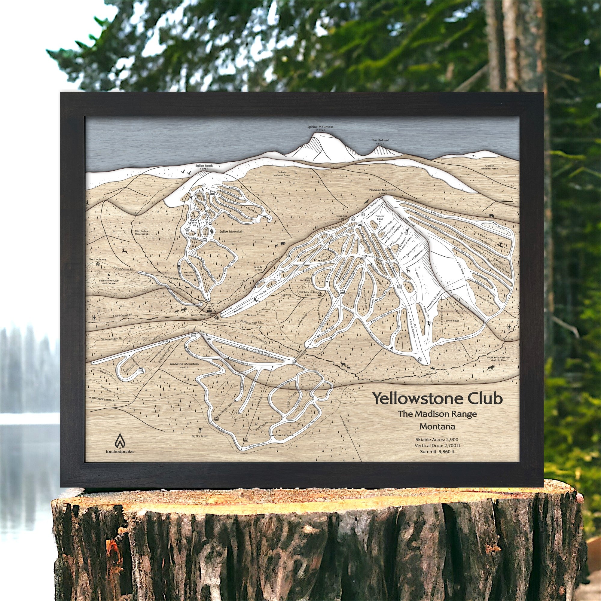 Framed large format wooden map of Yellowstone Club Ski Slopes on a wooden stump with a natural background. Torched Peaks authentic map, designed  by Founder Shawn Orecchio. 