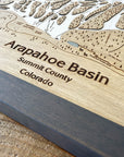 Wooden map of Arapahoe Basin, Summit County, Colorado with engraved text.