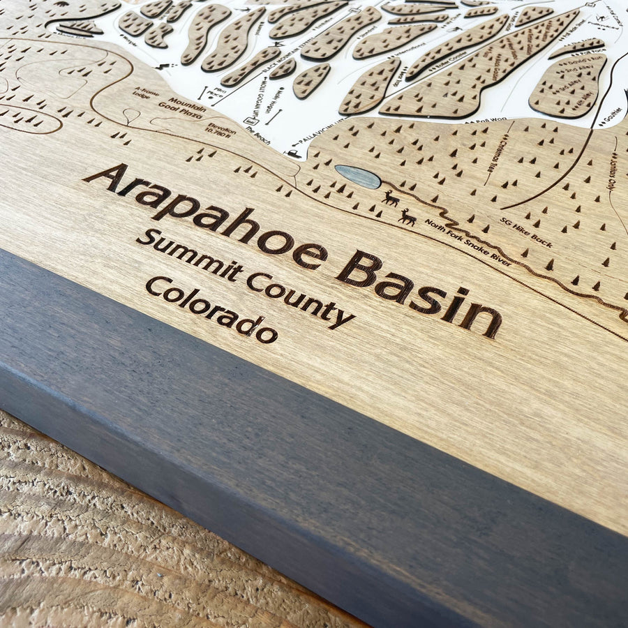 Wooden map of Arapahoe Basin, Summit County, Colorado with engraved text.
