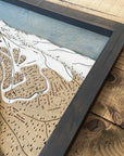 Wooden map of a ski resort with a detailed layout on a wooden surface