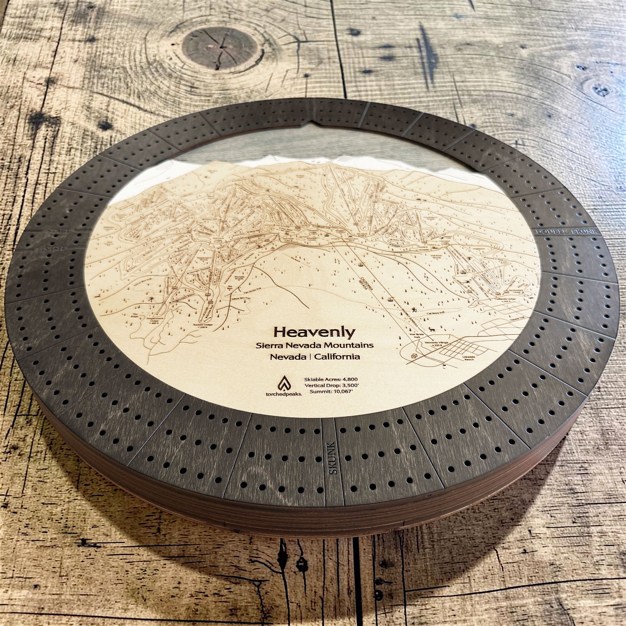 Full view of the handcrafted Heavenly Ski Map Cribbage Board featuring an engraved ski trail map, three-track layout, and premium layered wood construction.