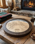 Heavenly Lake Tahoe wooden ski map cribbage board staged for game night in a cozy mountain cabin with coffee and fireplace.