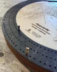 Angled close-up of the Heavenly Ski Map Cribbage Board highlighting engraved trails, three-track play, and premium wood construction.