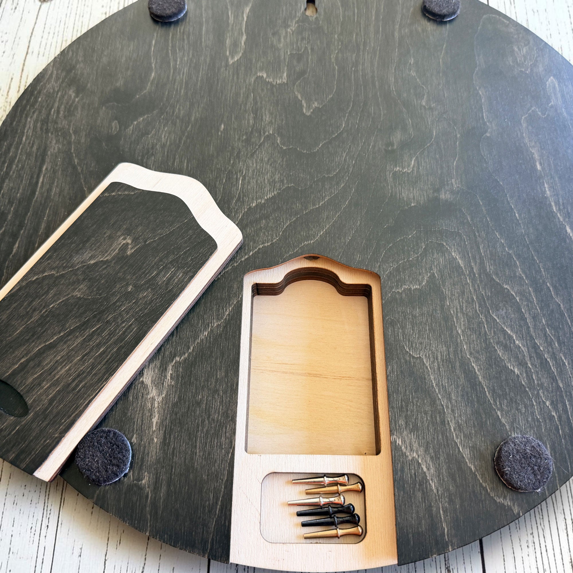 Hidden storage compartment inside the Heavenly Ski Map Cribbage Board designed to hold metal playing pegs and a deck of playing cards.